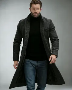 Full body view of a stylish man wearing a dark grey textured wool overcoat with jeans