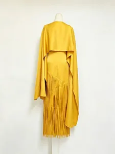 Elegant yellow fringe dress with matching cape overlay shown on a studio mannequin