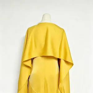Rear view of yellow acetate dress with matching shrug cape showing silky fabric texture