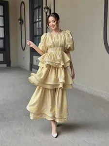Elegant tiered ruffle midi dress with puff sleeves and vibrant yellow floral print