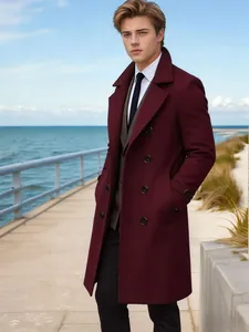 Stylish young man wearing a burgundy wool overcoat on a scenic coastal boardwalk.