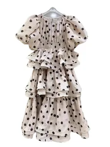Elegant polka dot puff sleeve tiered ruffle dress in cream with multi-layered design.