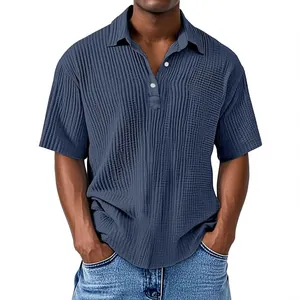Close-up view of a men's navy blue textured crinkle fabric polo shirt with buttoned collar