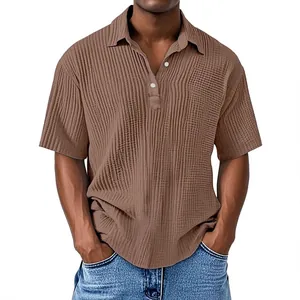 Detail shot of a men's brown short sleeve shirt with textured crepe fabric and lapel collar.