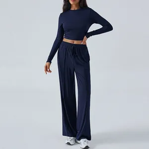 Two-piece navy blue lounge set featuring slim fit long-sleeve top and wide-leg drawstring pants