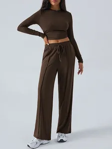 Brown two-piece sports set featuring a long sleeve crop top and wide-leg trousers