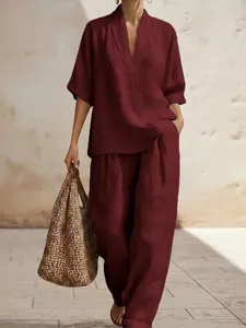Chic burgundy linen-blend two-piece set featuring V-neck top and wide-leg trousers.