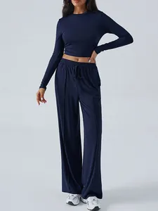 Navy blue two-piece lounge set with slim long sleeve crop top and wide leg pants