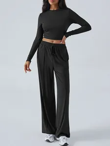 Elegant black women's long sleeve crop top and matching drawstring wide leg trousers set