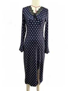 Elegant navy blue polka dot maxi dress with lace V-neck and side slit on mannequin