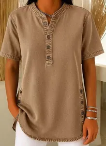 Detailed view of women's khaki denim shirt featuring button placket and side button accents.