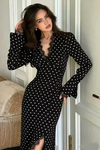 Elegant black polka dot maxi dress featuring a lace V-neck, long sleeves and side slit