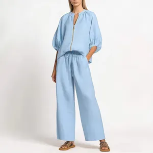 Two-piece light blue casual set with zipper top and wide-leg pants for women