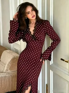 Detail showing the elegant burgundy polka dot dress with lace V-neck and sexy side slit