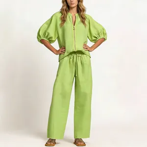 Detailed view of the lime green loose top and wide-leg trousers set on a model