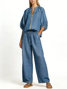 Detailed full-body view of a soft blue chambray lounge set with a zippered top and wide-leg pants