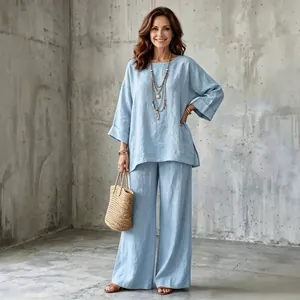 Full view of light blue cotton linen wide-leg pants set on model in minimalist setting.