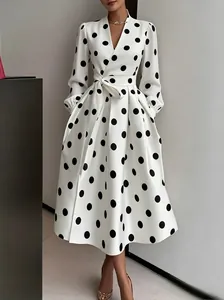 Close-up detail of a vintage Hepburn style white flared dress with large black polka dots