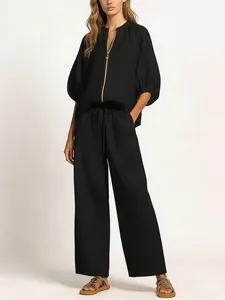 Casual black two-piece set with zip-up top and loose wide-leg trousers for women in spring