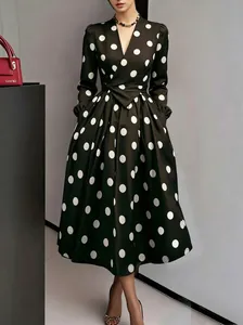Detail view of vintage Hepburn style polka dot dress with pleated skirt