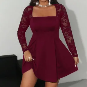Close-up of burgundy dress featuring delicate lace sleeves and elegant square neckline.