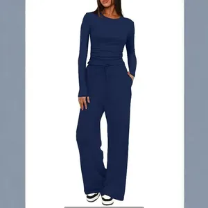 Women's navy blue two-piece lounge set with long sleeve top and wide leg pants.