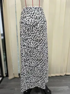 Detail of long mermaid skirt with black and white abstract feather print pattern