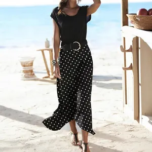 Detailed view of a summer resort style black and white polka dot fishtail midi skirt