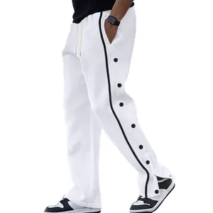 Vue latérale du pantalon de jogging blanc pour homme avec bandes latérales et boutons-pression
