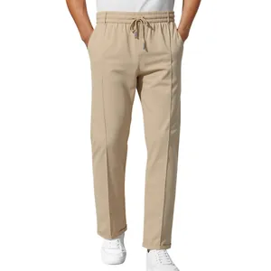 Close-up of men's beige slim-fit business casual trousers with drawstring waist.