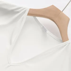 Close-up detail of the V-neckline and breathable fabric on a white men's athletic vest.