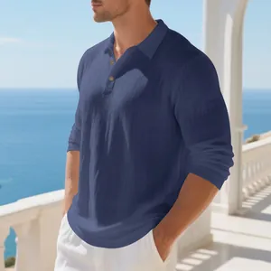 Detailed view of navy blue men's breathable linen long sleeve polo shirt in a seaside setting