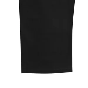 Close-up of the stitching and linen fabric texture on black men's casual trouser hem.