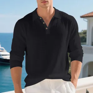 Men's black linen cotton polo shirt with long sleeves and buttons against a luxury sea view