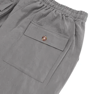 Close-up of grey linen casual pants showing elastic waistband and cargo pocket detail.