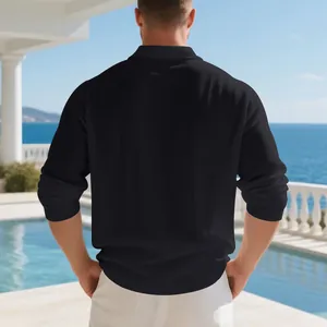Back view of a casual black linen-blend long sleeve polo shirt for men at a seaside resort