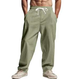 Detailed view of men's loose light green linen casual pants with drawstring waist