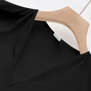 Detail view of a men's black quick-dry V-neck athletic tank top on a wooden hanger.