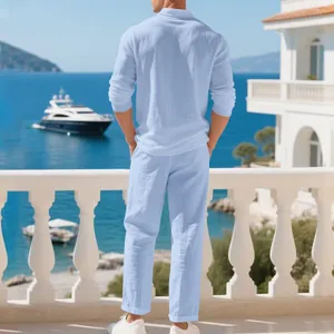 Back view of men's breathable linen casual set in light blue on a sea view balcony