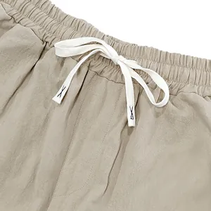 Close-up view of men's loose linen casual pants with elastic drawstring waistband