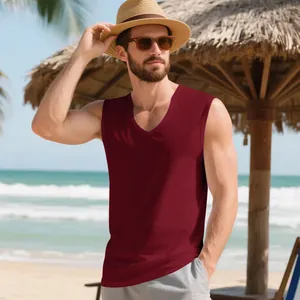 Athletic man wearing a maroon V-neck muscle training tank top on a tropical sunny beach