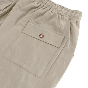 Detailed macro view of the pocket and button on men's khaki linen casual beach trousers