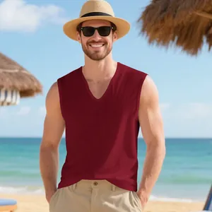 Breathable burgundy V-neck tank top for men shown in a sunny beach vacation setting
