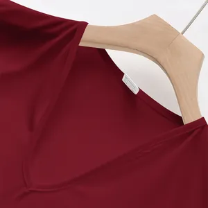 Detailed macro view of maroon V-neck tank top showing stitching and quick-dry fabric