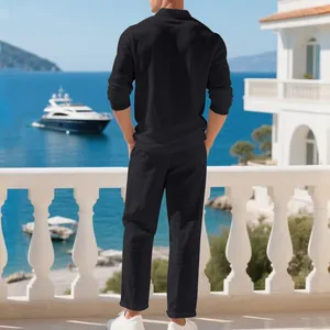 Elegant back view of a men's black breathable linen suit on a sunny seaside balcony.