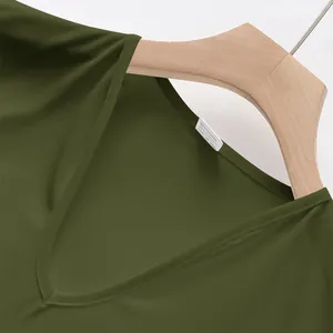 Detail showing the V-neckline and breathable fabric of this green sports tank top