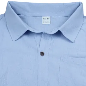 Close-up of light blue linen shirt collar and fabric texture with visible size M tag detail