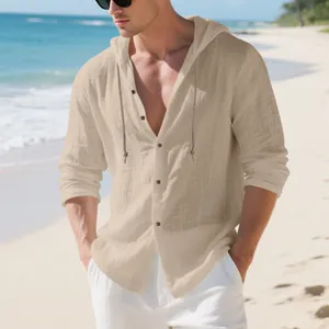 Relaxed fit men's long sleeve linen hooded shirt with buttons shown in a beach setting