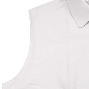 A detail shot showing the textured white linen fabric and sleeveless shirt collar