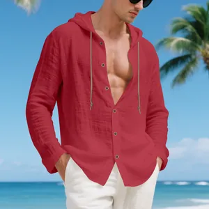 Close-up detail of a men's loose red linen hooded shirt with casual button closure at beach.